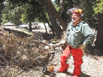 Ben pauses to rest while working with the chainsaw